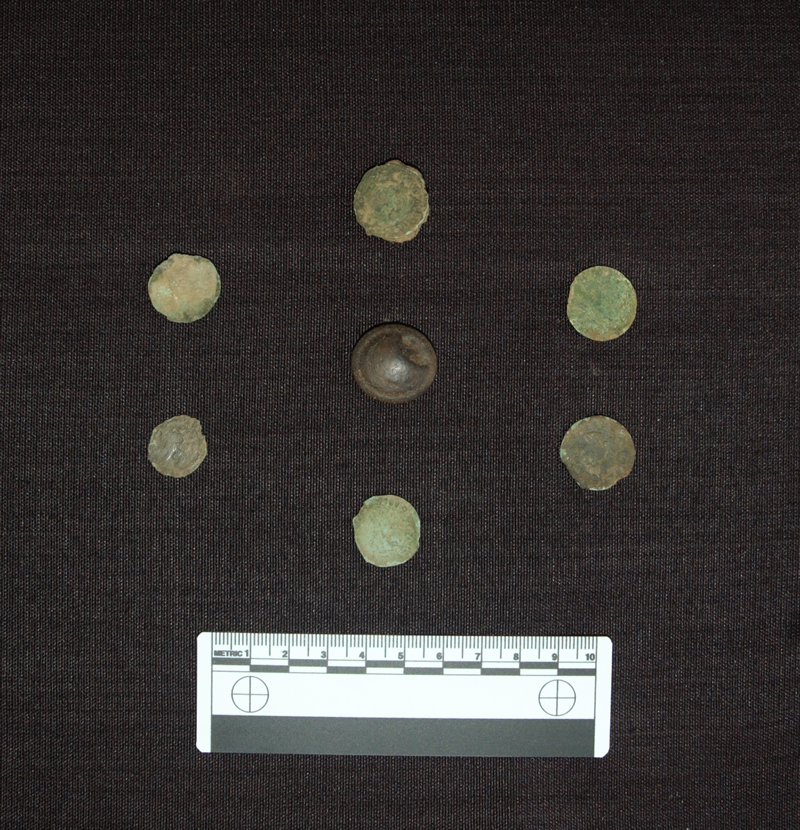 Six of the medieval coins and one of the gaming counters recovered from Netherton Cross