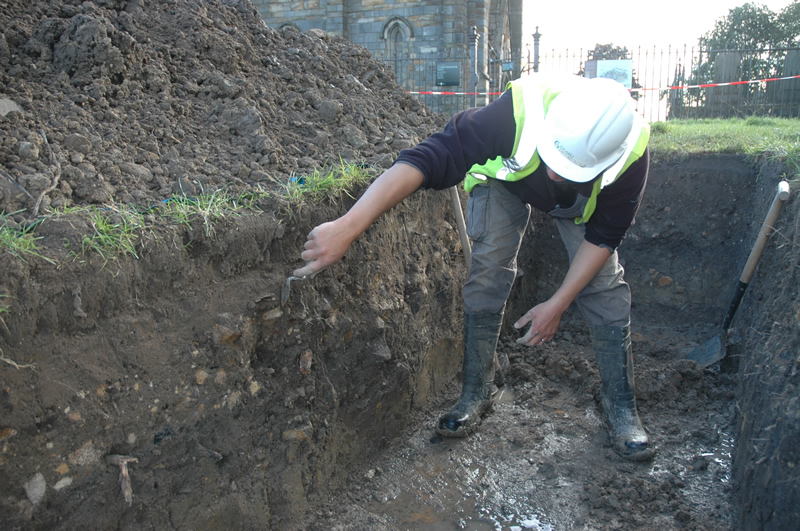 Cleaning up a trench near the abbey tower